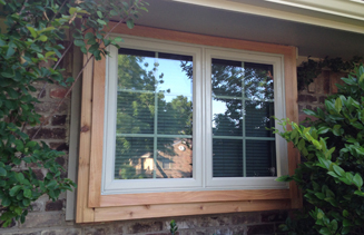 Twin casement window with colonial lite grids and cedar trim