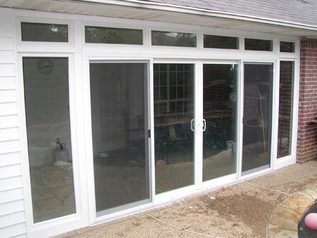 Sliding four lite door with sidelites and transomes