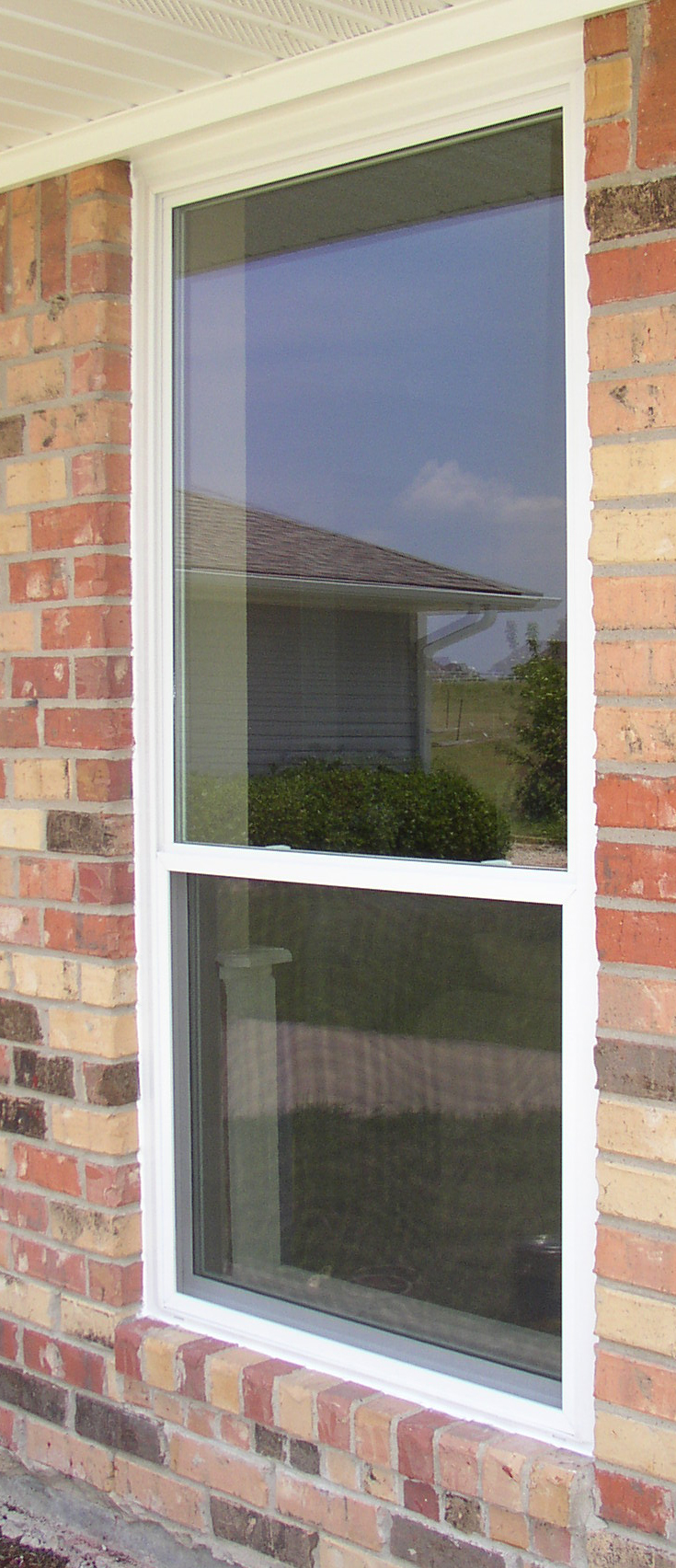 Alside Mezzo Double Hung Oriole with no grids in a brick opening.  This window has a frame that is close to three and one half inches in width for a slightly bulky wood window look on the exterior of the homes windows